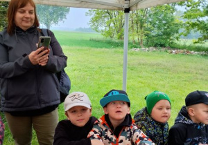 Chłopcy siedzą przy stole i pozują do zdjecia