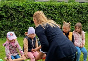 Pani i dzieci przyglądają się dziewczynce z wałkiem