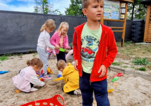Buziaki wesoło bawią się na przedszkolnym placu zabaw.