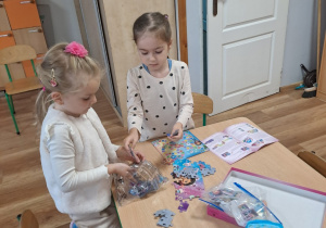 Michasia z Gabrysią układają puzzle