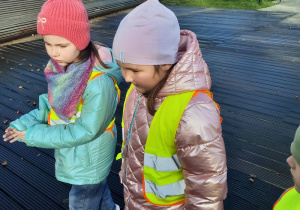 Dziewczynki spacerują po drewnianej platformie