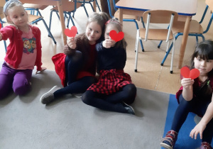 Dziewczynki prezentują czerwone serduszka.