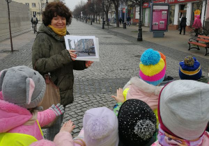 Dzieci pokazuję ulicę Królewską, którą na za zdjęciu prezentuje im nauczycielka.