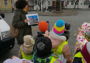 Dzieci stoją przed pomnikiem Józefa Piłsudskiego.