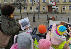 Dzieci patrzą na budynek Urzędu Miasta.
