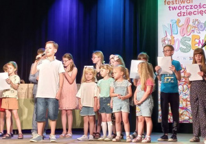 Dziewczynki z grupy Tuptusie na scenie wraz z innymi dziećmi