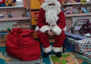 Mikołaj z prezentami czeka siedzi na krześle
