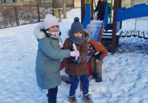 Pola z Adasiem niosą duży kawałek lodu